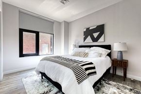 Passaic apartment for rent - A bedroom with a large bed and a window.