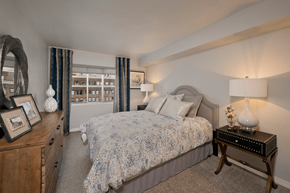 Seattle apartment for rent - A bedroom with a bed, nightstand, and a dresser with a mirror