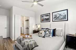 Colorado Springs apartment for rent - A bedroom with a bed, dresser, and a ceiling fan.
