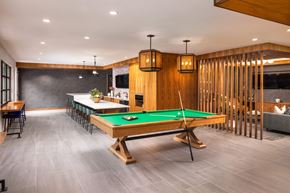 Denver apartment for rent - A pool table is in the middle of a room with a bar and a couch.