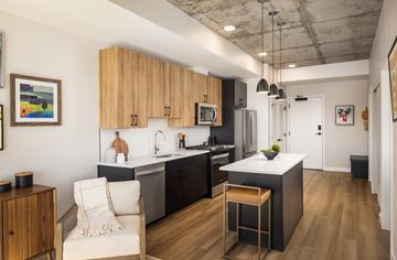 Englewood apartment for rent - A kitchen with a white chair and a bar stool.