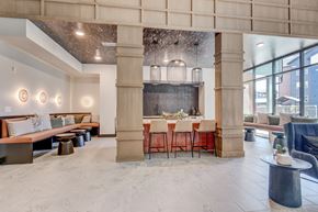 Colorado Springs apartment for rent - A modern dining area with a long table set for a meal.