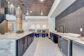 Colorado Springs apartment for rent - A modern kitchen with a marble countertop and dark cabinets.