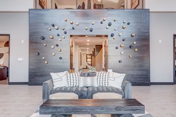 Colorado Springs apartment for rent - A modern living room with a grey couch and a wooden coffee table.