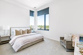 Denver apartment for rent - a bedroom with a bed and three windows