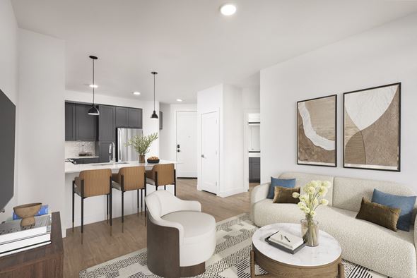Arvada apartment for rent - A modern living room with a white sofa, a coffee table, and a dining table with chairs.