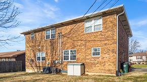 Fort Wright apartment for rent - A red brick house with a white door and windows.