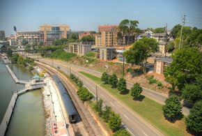 Knoxville apartment for rent - A train is on the tracks near a body of water.at Maplehurst Apartments, Tennessee