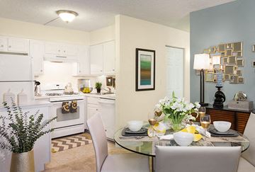 Framingham apartment for rent - A modern kitchen with a dining table set for two.