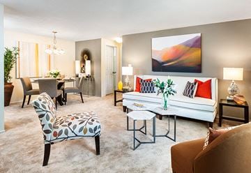 Plainville apartment for rent - A living room with a white couch and a painting on the wall.