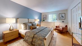 Plainville apartment for rent - A bedroom with a large bed and a chair.