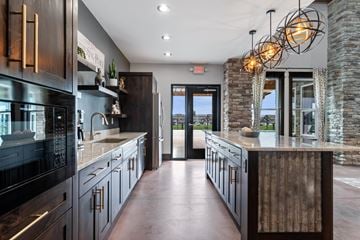 Chippewa Falls apartment for rent - A modern kitchen with dark wood cabinets and a stone wall.