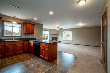 Eau Claire apartment for rent - A kitchen with brown cabinets and a black countertop.