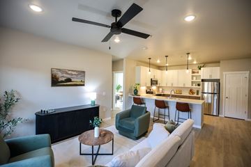 Eau Claire apartment for rent - A living room with a ceiling fan and a painting on the wall.