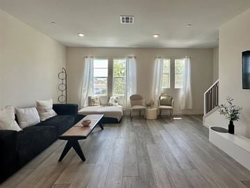Arcadia townhouse for rent - A living room with a black couch and a wooden coffee table.