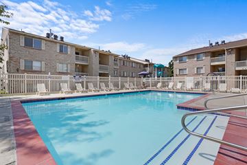 Layton apartment for rent - A swimming pool in front of apartment buildings.