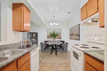 Salt Lake City apartment for rent - A kitchen with a table and chairs in the middle.