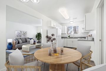 Salt Lake City apartment for rent - A modern living room with a round wooden table and chairs.