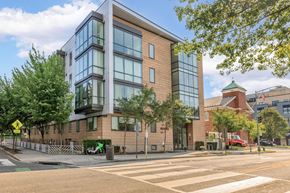 Washington apartment for rent - an apartment building on a street corner with a crosswalk in front of it