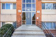 Hyattsville apartment for rent - The front of a building with a glass door and a sign that says "Cleveland Crossing".