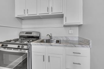 Washington apartment for rent - A modern kitchen with a stove and sink.