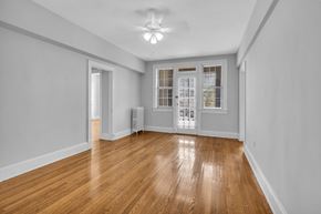 Washington apartment for rent - A room with wooden floors and white walls.