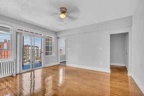 Washington apartment for rent - A room with a ceiling fan and a sliding glass door.