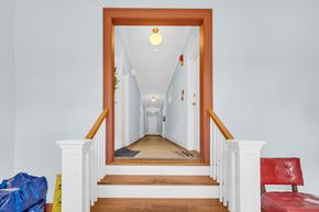 Washington apartment for rent - A hallway with a red chair and a blue bag on the floor.