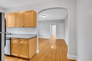 Washington apartment for rent - an empty kitchen with wood floors and wooden cabinets