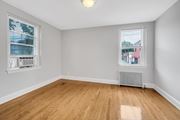 Washington apartment for rent - an empty room with wood flooring and two windows