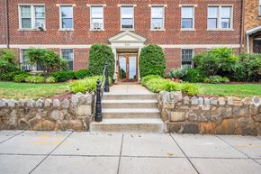 Washington apartment for rent - the front door of a brick building with stairs in front of it