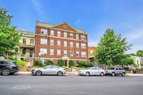 Washington apartment for rent - a large brick building with cars parked in front of it