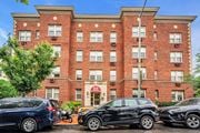 Washington apartment for rent - a large brick building with cars parked in front of it