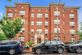 Washington apartment for rent - a large brick building with cars parked in front of it