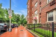 Washington apartment for rent - a sidewalk in front of a brick building with a speed limit sign