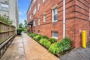 Washington apartment for rent - a brick building with a sidewalk and a yellow pole