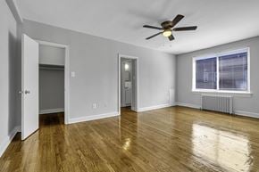Washington apartment for rent - an empty living room with wood floors and a ceiling fan