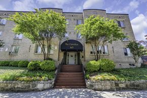 Washington apartment for rent - a brick building with stairs and trees in front of it