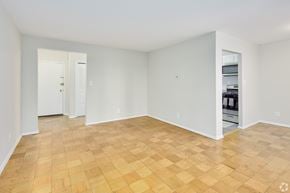 Lanham apartment for rent - Empty room with wooden flooring and white walls.