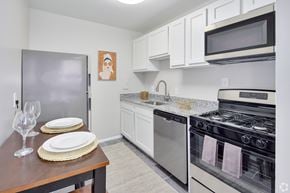 Lanham apartment for rent - A kitchen with a stove, oven, and refrigerator.
