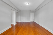 Washington apartment for rent - an empty living room with wood floors and white walls