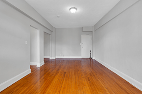 Washington apartment for rent - an empty living room with wood floors and white walls