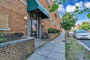 Washington apartment for rent - a brick building with a car parked on the sidewalk
