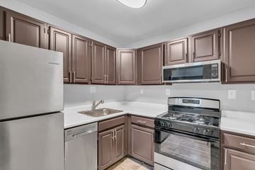 Hyattsville apartment for rent - A kitchen with brown cabinets and stainless steel appliances.