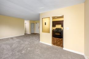 Maryland apartment for rent - A room with a carpeted floor and a doorway leading to another room.