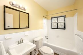 Silver Spring apartment for rent - A bathroom with a white toilet, sink, and bathtub.