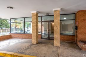Silver Spring apartment for rent - A building entrance with a glass door flanked by two pillars.