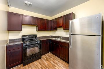 Silver Spring apartment for rent - A kitchen with wooden cabinets and a stainless steel refrigerator.