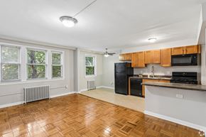 Washington apartment for rent - A kitchen with wooden floors and white walls.