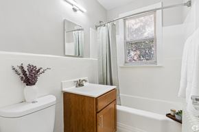 Washington apartment for rent - A white toilet sits next to a sink in a bathroom.